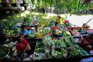 Meet the Local Expert Khun Maitree Boats filled with fresh product at Khlong Lat Mayom Floating Market